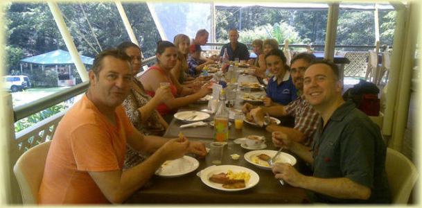 a group of people sitting at a table eating food