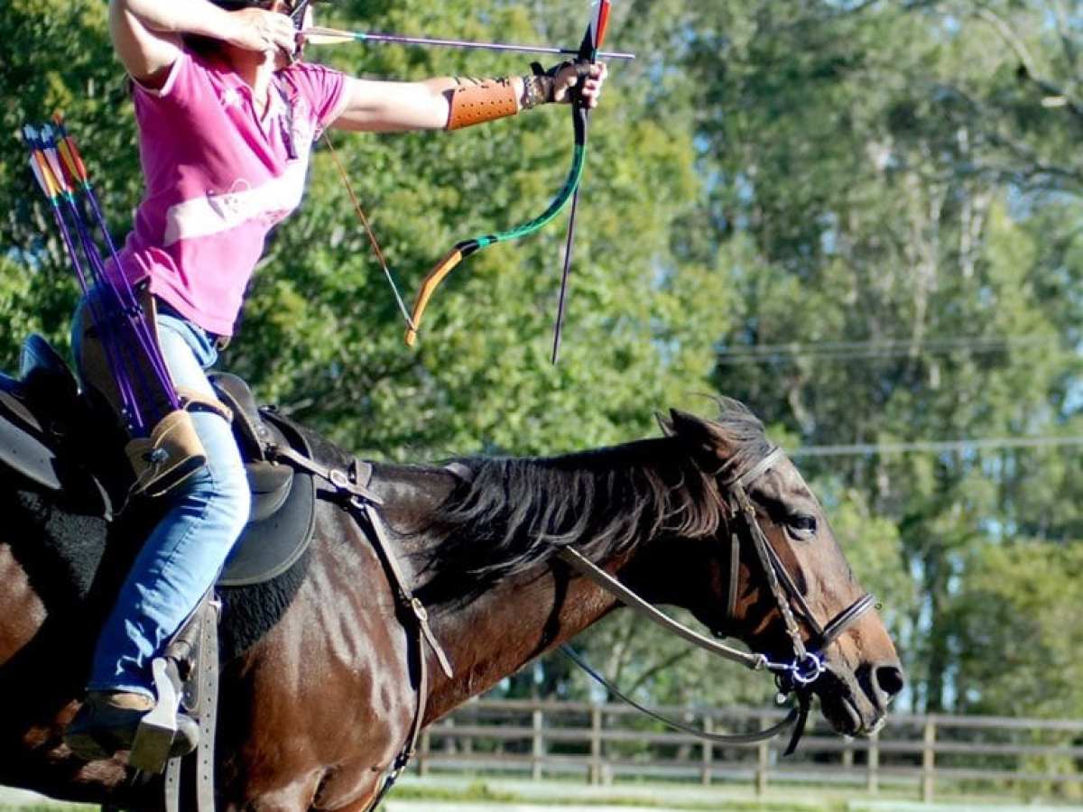 a woman riding a horse